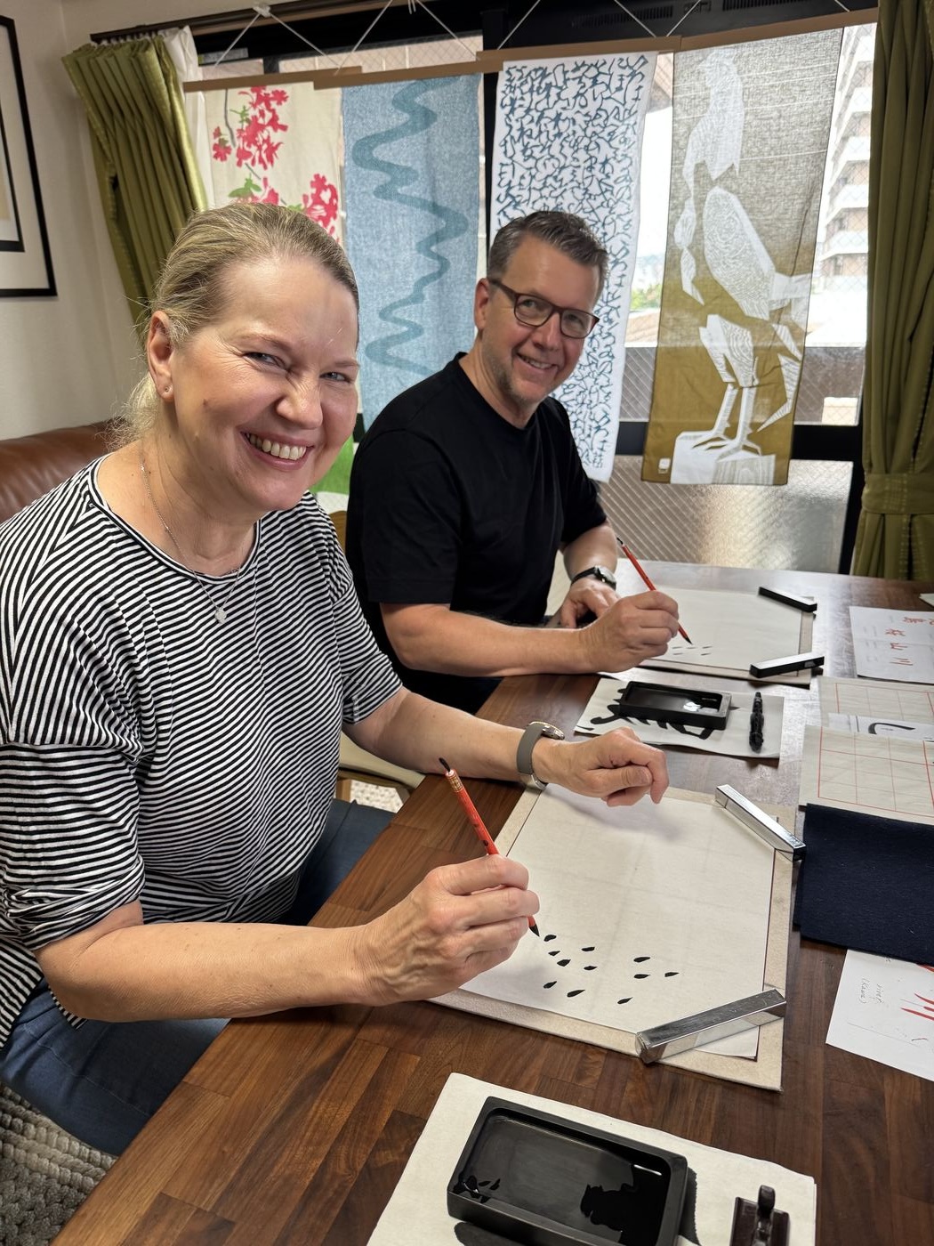 Couple practicing Japanese calligraphy
